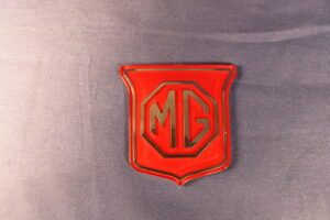 (9) MGB BHH829 SHIELD GRILL BADGE RED ON RED (HONEYCOMBE GRILLE)
